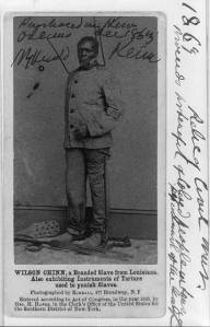 Wilson Chinn, a branded slave from Louisiana--Also exhibiting instruments of torture used to punish slaves c1863 carte de visite Library of Congress 